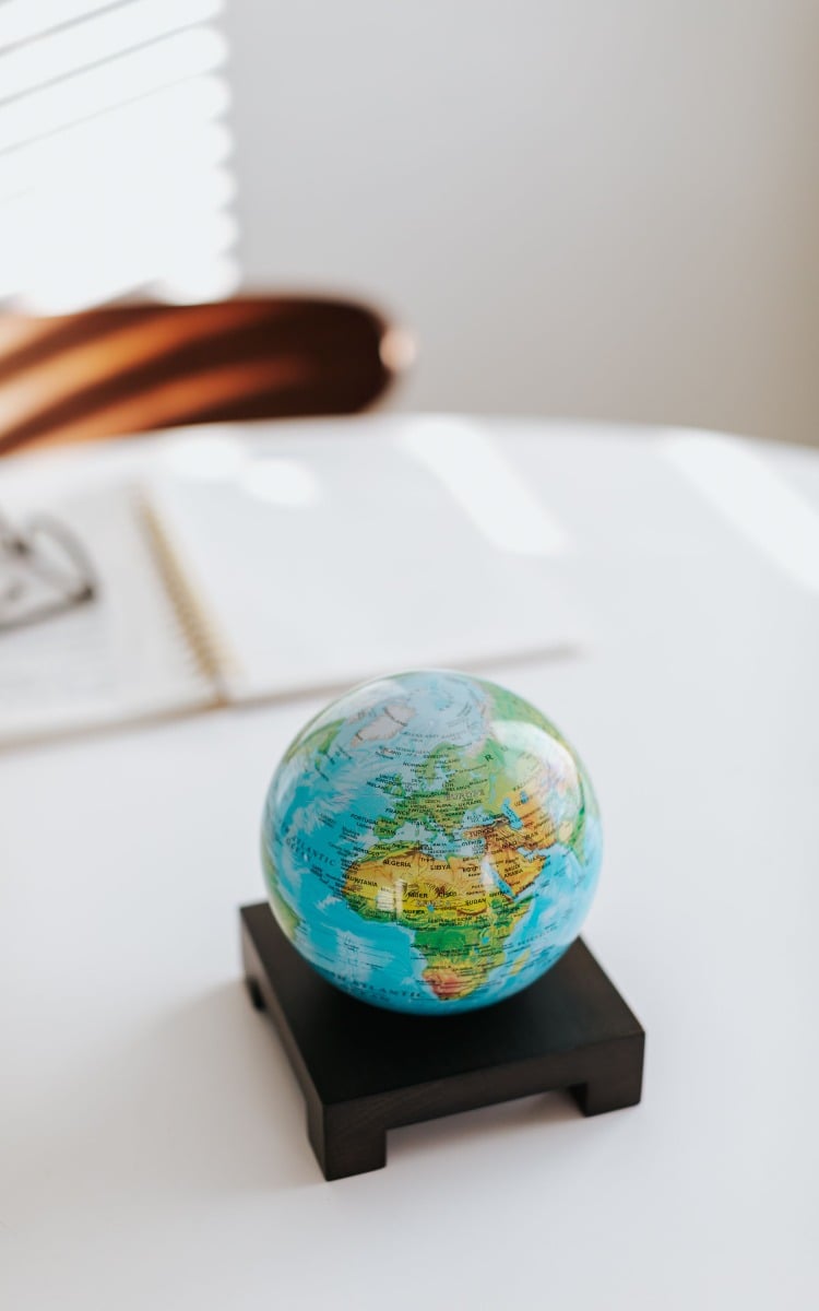 Blue relief map globe on wooden base