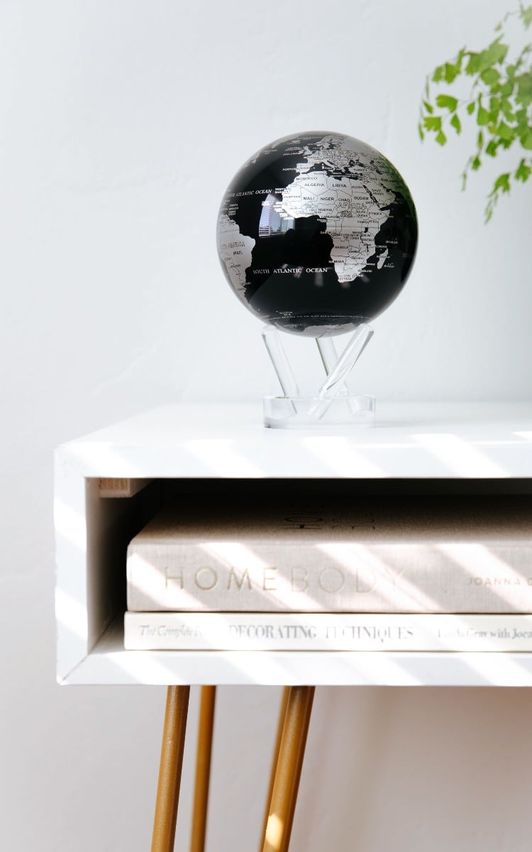 Black and Silver globe on table
